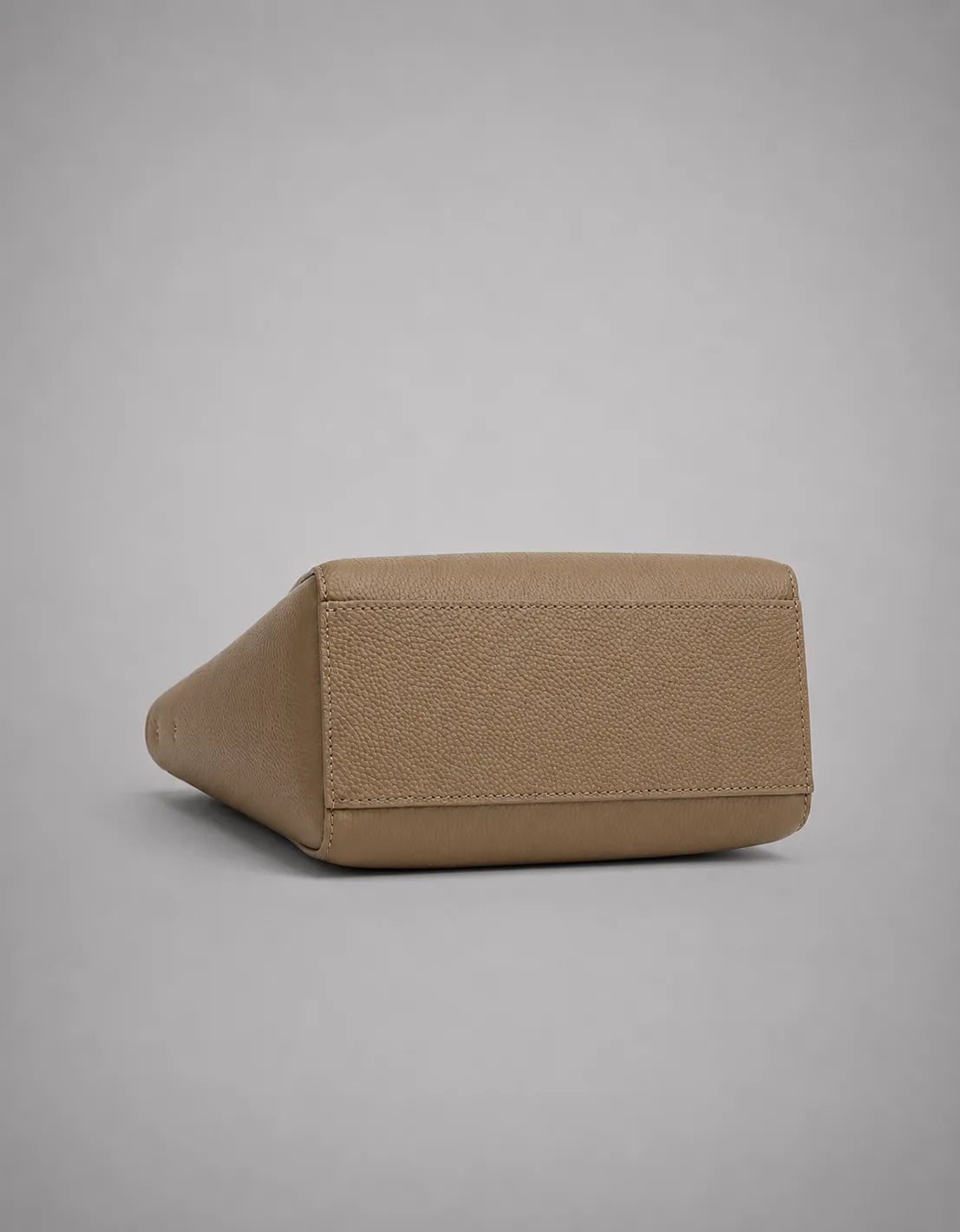 Base detail of the Louise genuine leather tote bag in elephant grey showing structured construction and premium craftsmanship