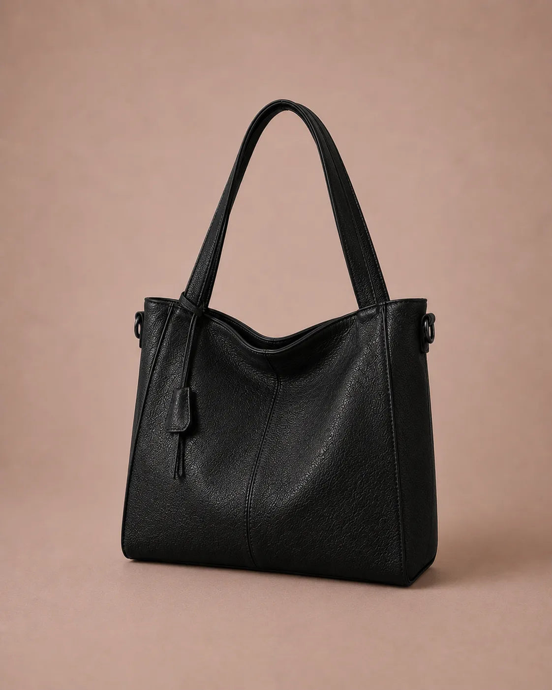 Front angled view of The Eleanor luxury genuine leather tote bag in Black with a timeless silhouette for modern workdays and everyday elegance.