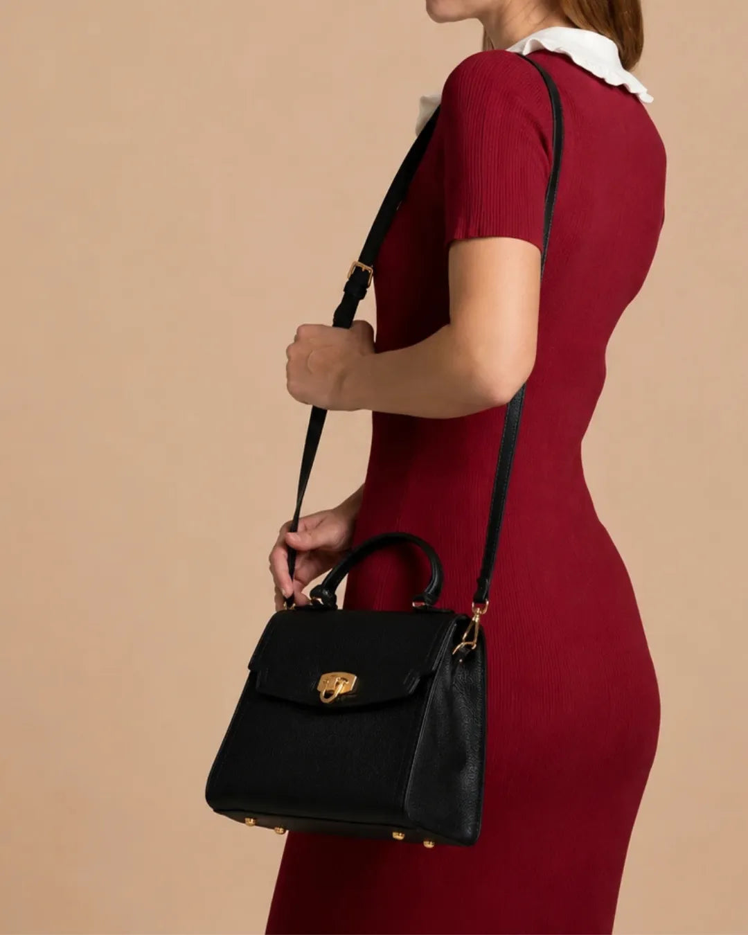 Model wearing The Beatrice genuine leather crossbody bag, featuring its adjustable leather strap, structured silhouette, premium cowhide leather and versatile day-to-evening design.