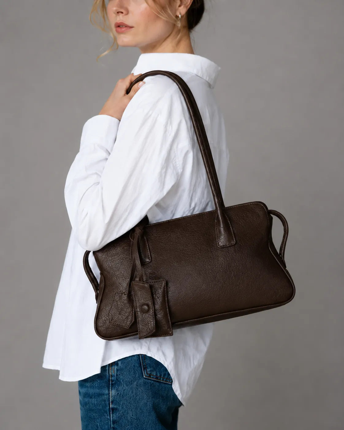 Model wearing The Georgia luxury genuine leather shoulder bag in Dark Chocolate, elegant women's leather handbag designed for everyday style and versatility.