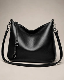 Front view of the Noémie soft genuine leather hobo shoulder bag in black showing the relaxed silhouette and double straps.