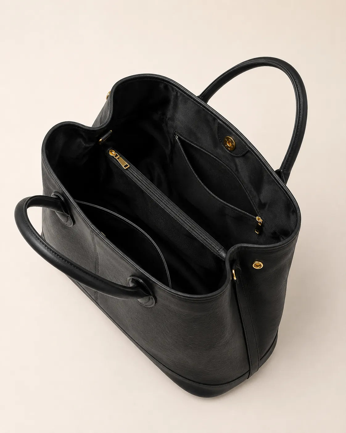 Interior view of the Odile large structured genuine leather tote bag in black showing the lining and zip pocket.