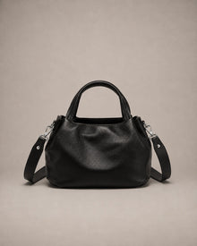 Front view of the Pauline genuine leather top handle crossbody bag in Black featuring soft pebbled leather, a structured silhouette and an adjustable shoulder strap by Malena London.