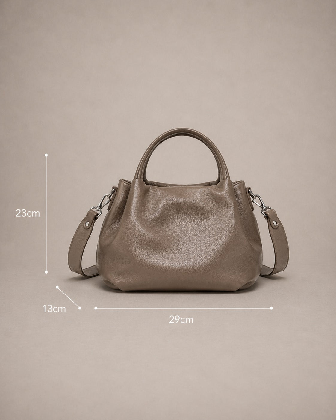 Dimensions of the Pauline genuine leather top handle crossbody bag in Taupe measuring 29 cm wide, 23 cm high and 13 cm deep by Malena London.