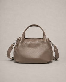 Front view of the Pauline genuine leather top handle crossbody bag in taupe featuring a softly structured silhouette, premium pebbled leather and adjustable shoulder strap by Malena London.