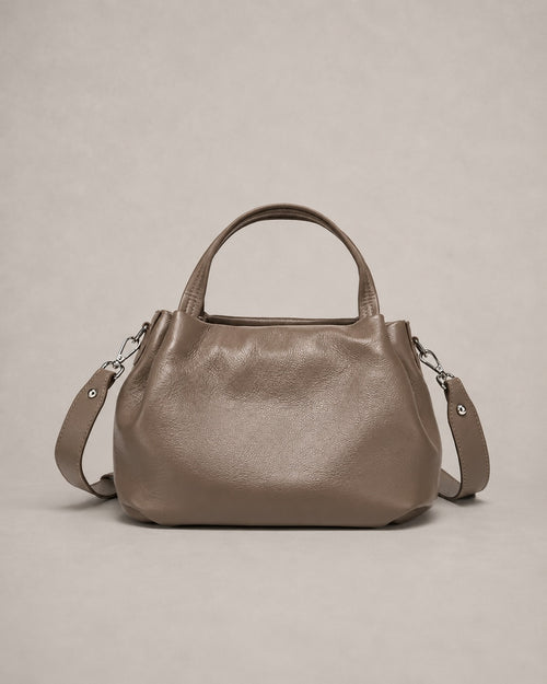 Front view of the Pauline genuine leather top handle crossbody bag in taupe featuring a softly structured silhouette, premium pebbled leather and adjustable shoulder strap by Malena London.
