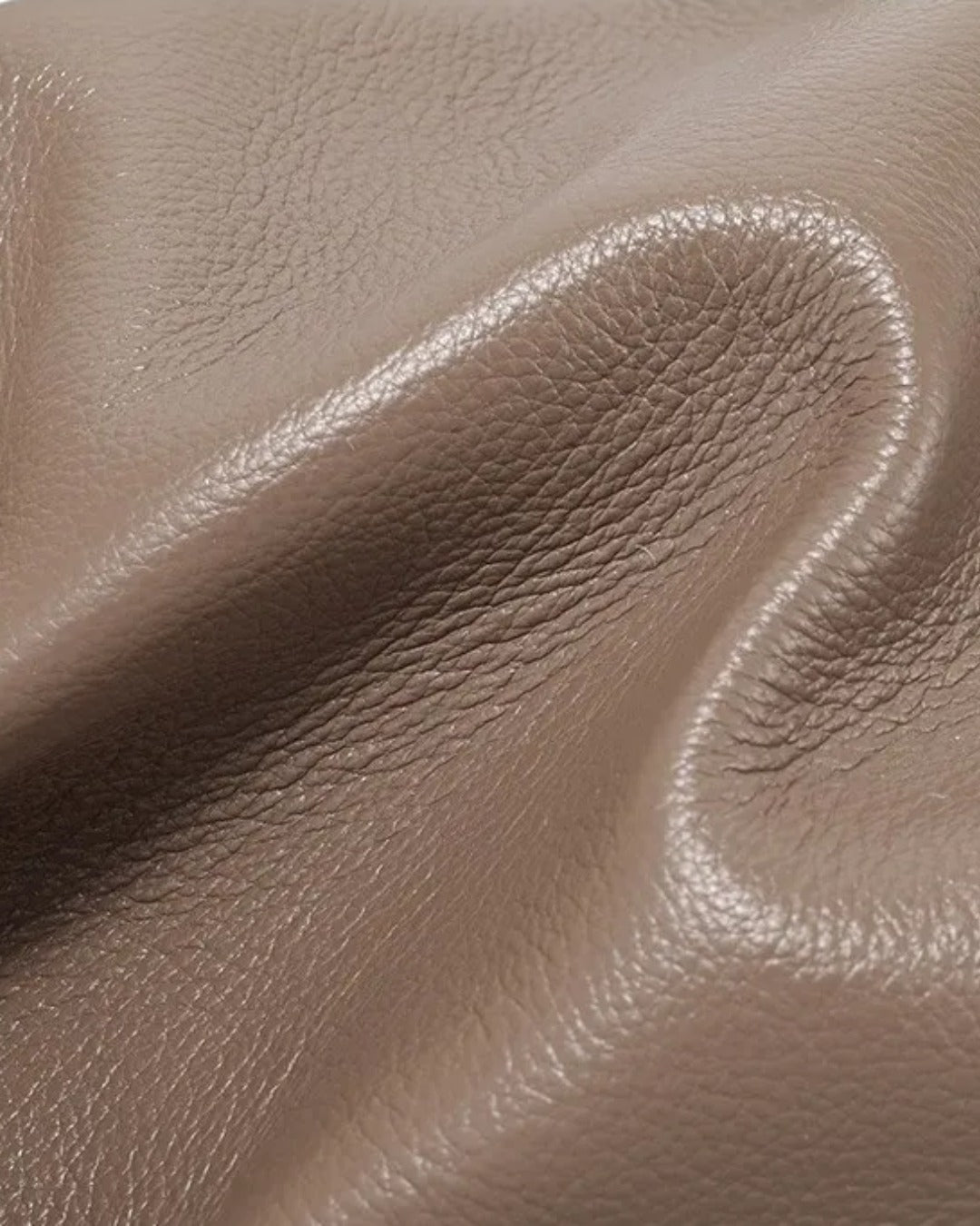 Close-up of the Pauline genuine leather top handle crossbody bag in Taupe highlighting the soft pebbled leather texture and premium craftsmanship by Malena London.