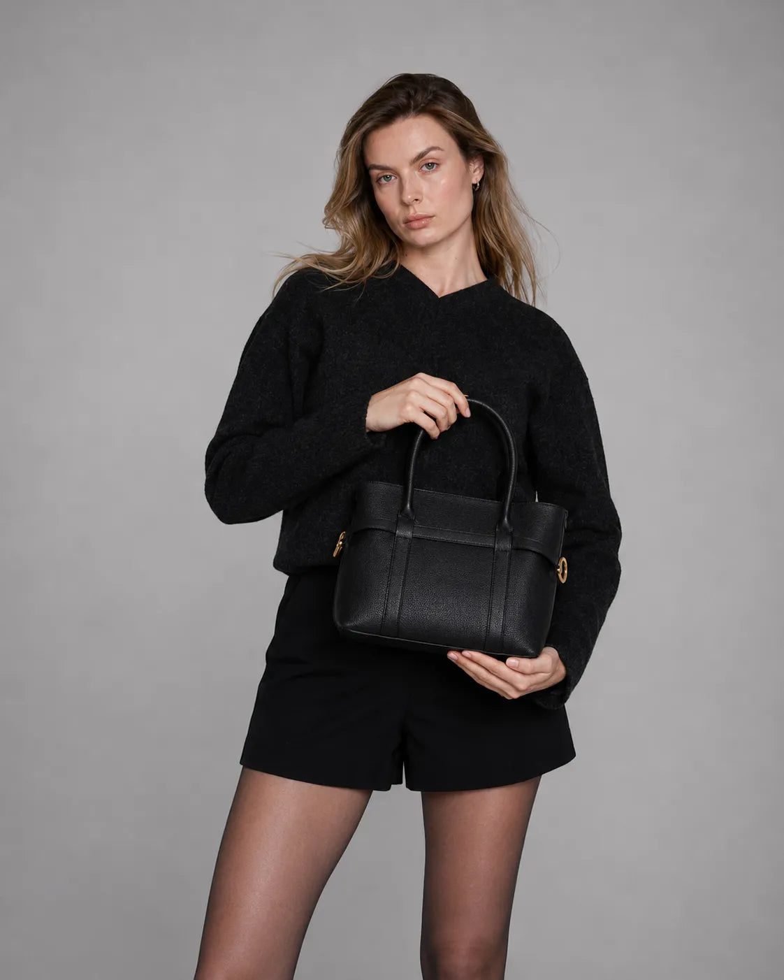 The Rose Black genuine leather tote bag showcased by model. Timeless women's leather handbag with a structured silhouette for work, travel and everyday use.