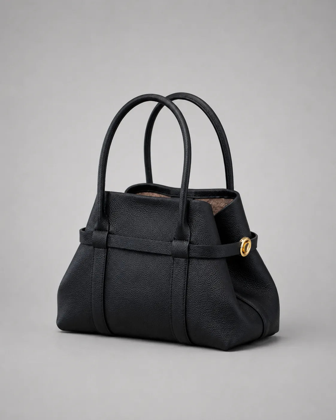 Rose Leather Tote Bag in Black genuine leather shown from an angled front view with the side straps secured, highlighting its structured silhouette, premium pebbled leather and gold-tone hardware.