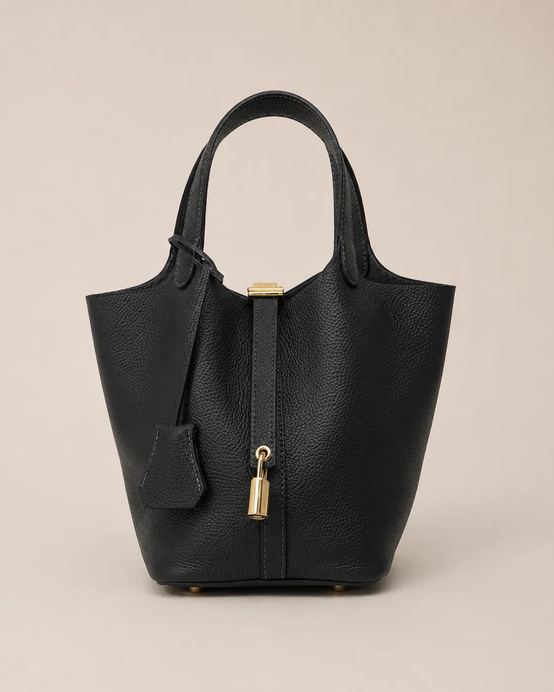 Front view of Scarlett genuine leather bucket tote bag in black leather with signature lock detail and structured silhouette