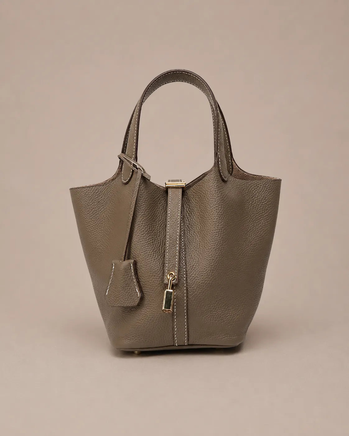 Scarlett genuine leather bucket tote bag in dark gray leather front view with signature lock closure and minimalist design