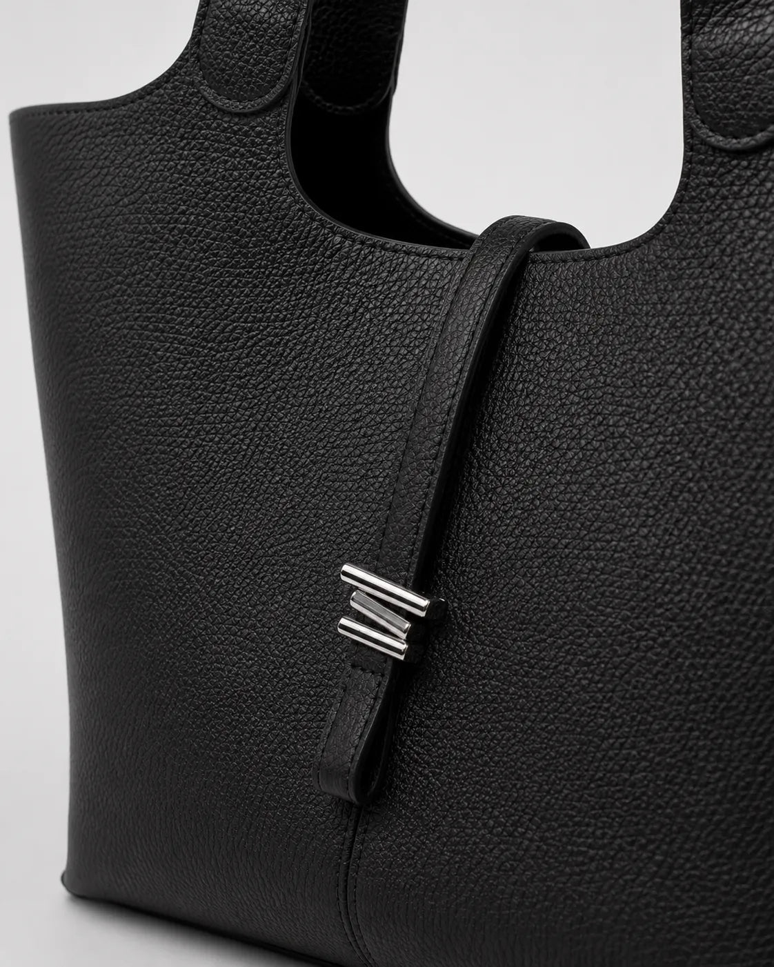 Close-up detail of the Victoria genuine leather work tote bag in black, showcasing the textured leather finish, refined closure detail and premium craftsmanship.