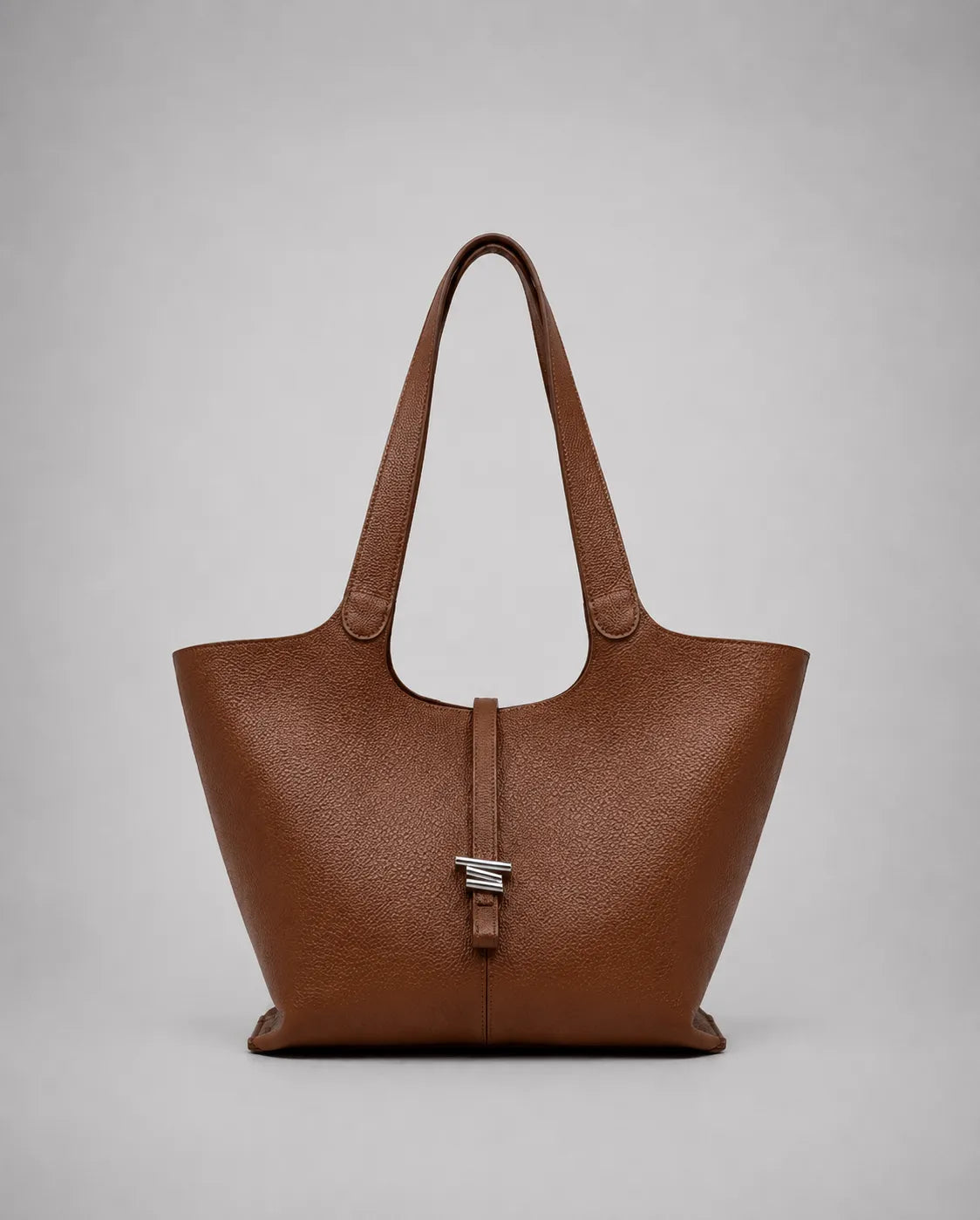 Victoria genuine leather work tote bag in brown displayed from the front, featuring a spacious silhouette, long shoulder straps and a timeless design for work and everyday use.