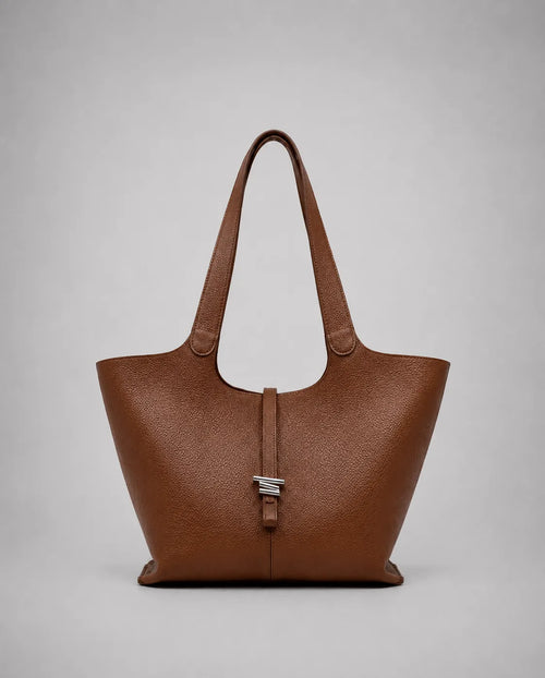 Victoria genuine leather work tote bag in brown displayed from the front, featuring a spacious silhouette, long shoulder straps and a timeless design for work and everyday use.