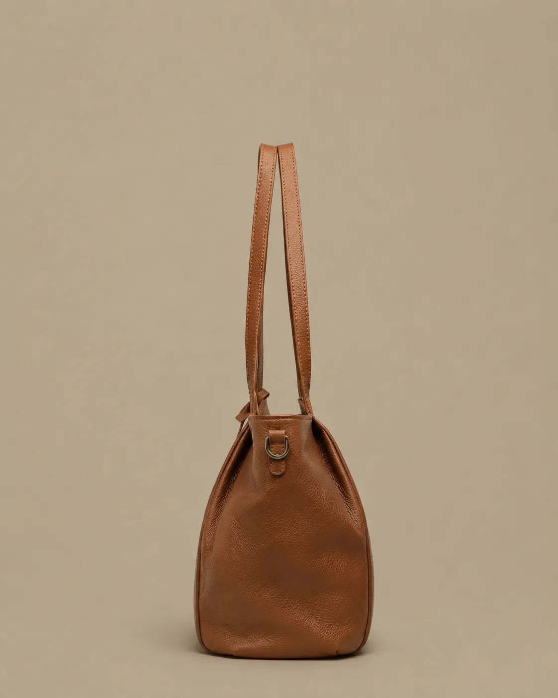 Side profile of The Viney genuine leather work bag in Brown highlighting its spacious shape and comfortable shoulder straps.