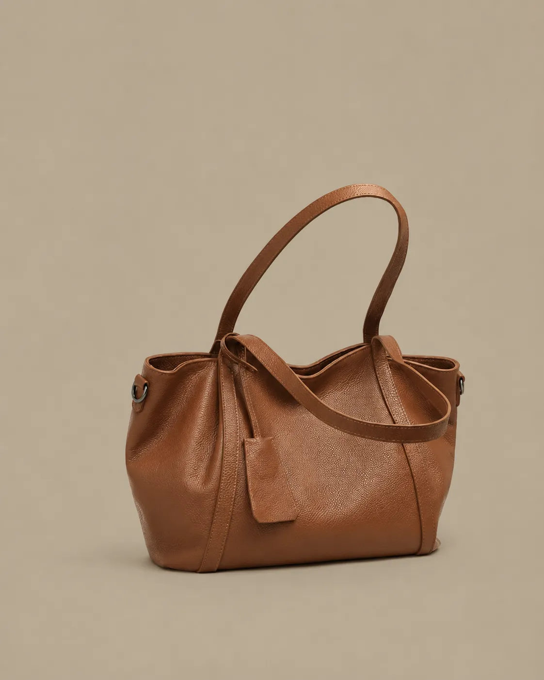 Angled front view of The Viney women's genuine leather shoulder bag in Brown with a soft silhouette and elegant everyday styling.
