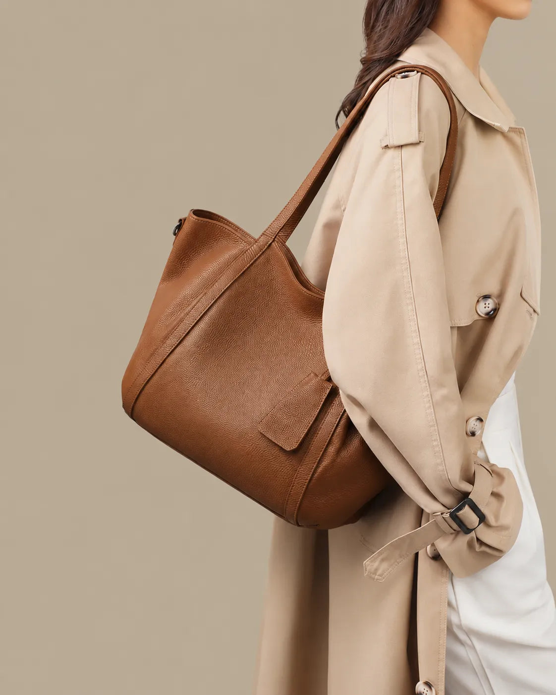 Side profile of a model wearing The Viney women's genuine leather shoulder bag in Brown with a spacious design for everyday commuting.